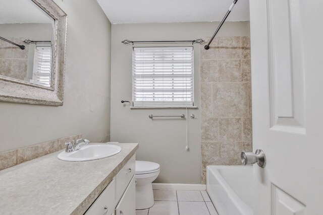 full bathroom featuring vanity, tiled shower / bath, tile patterned floors, and toilet