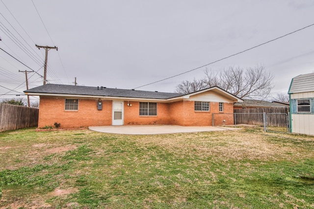 back of property featuring a yard and a patio area