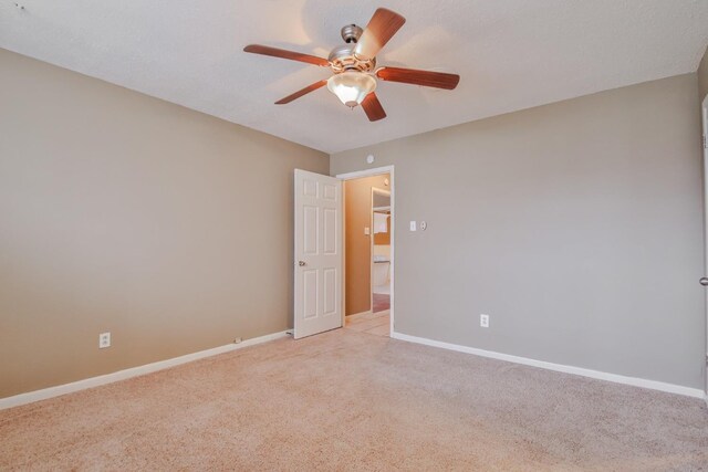 carpeted empty room with a textured ceiling and ceiling fan