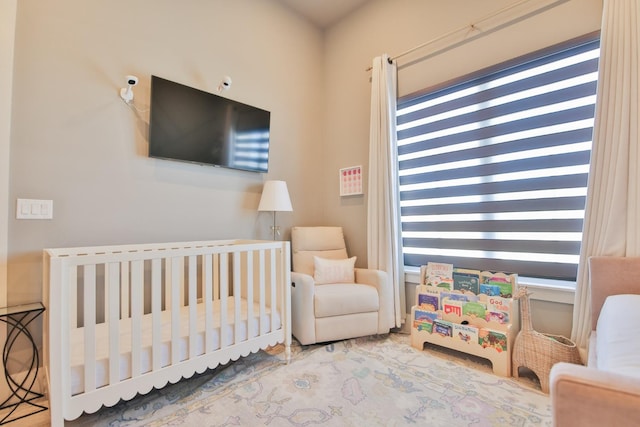 bedroom featuring a nursery area