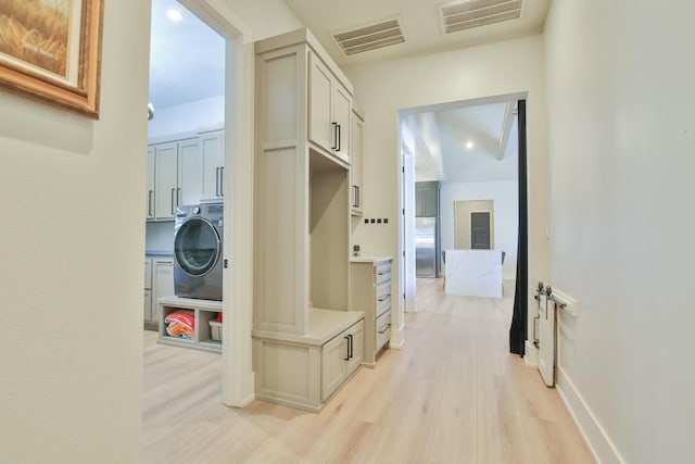 mudroom featuring washer / clothes dryer and light wood-type flooring