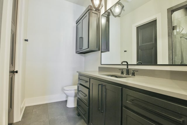 bathroom with tile patterned floors, vanity, toilet, and a shower