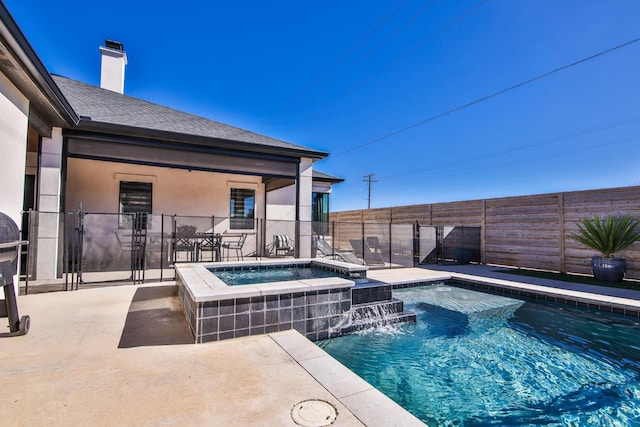 view of swimming pool featuring an in ground hot tub, pool water feature, and a patio area