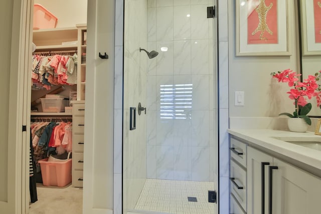 bathroom featuring vanity and a shower with door