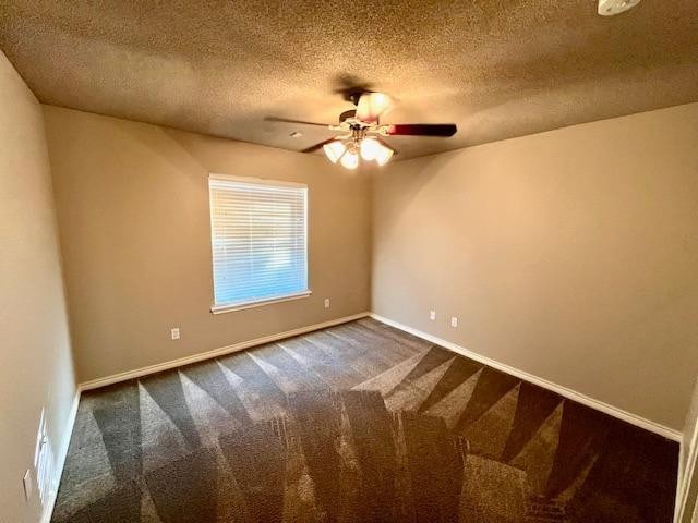 carpeted spare room with ceiling fan and a textured ceiling