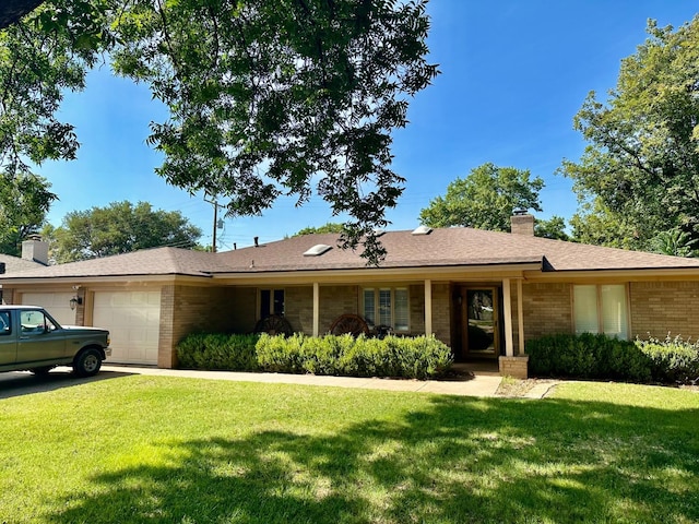 ranch-style house with a garage and a front lawn