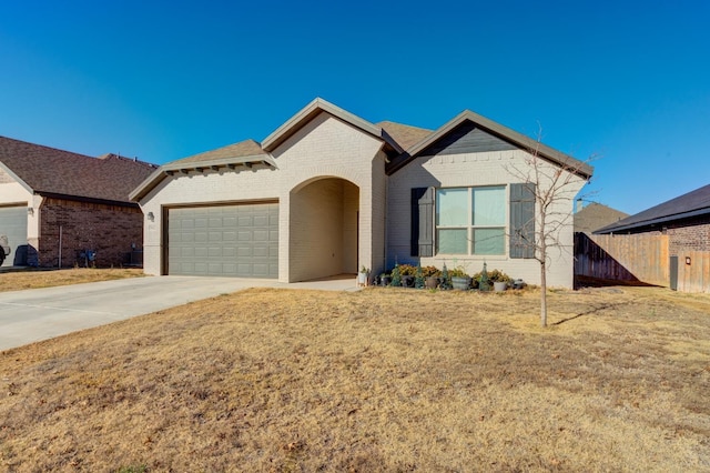 view of front of home featuring a garage and a front lawn