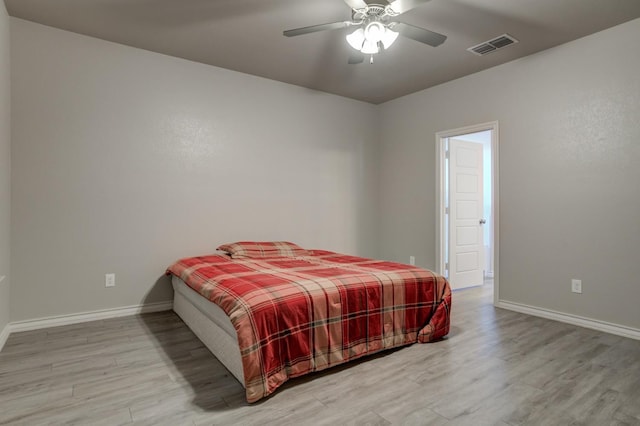 bedroom with ceiling fan and light hardwood / wood-style flooring