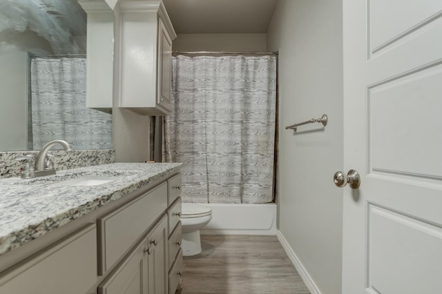 full bathroom with vanity, toilet, wood-type flooring, and shower / bath combo