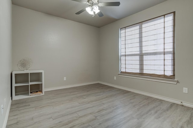 spare room featuring light hardwood / wood-style flooring and ceiling fan