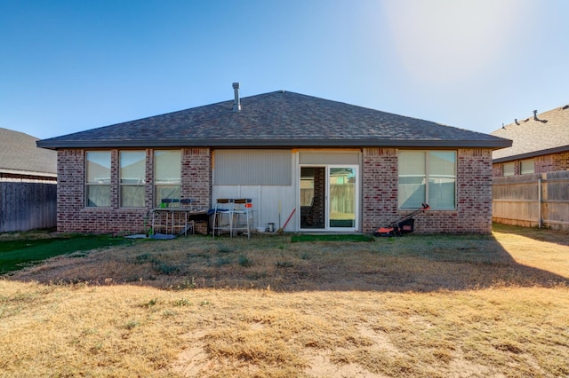 back of property featuring a lawn