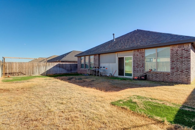 back of house featuring a yard