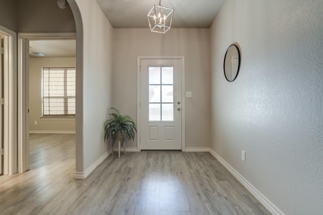 entryway featuring an inviting chandelier and light hardwood / wood-style floors