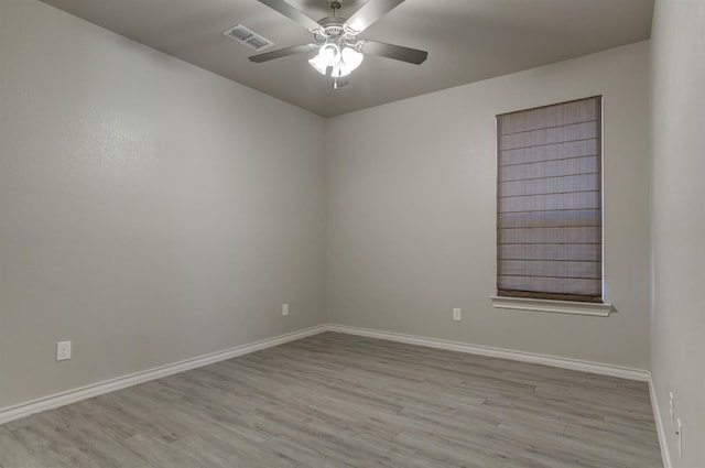 empty room with ceiling fan and light wood-type flooring