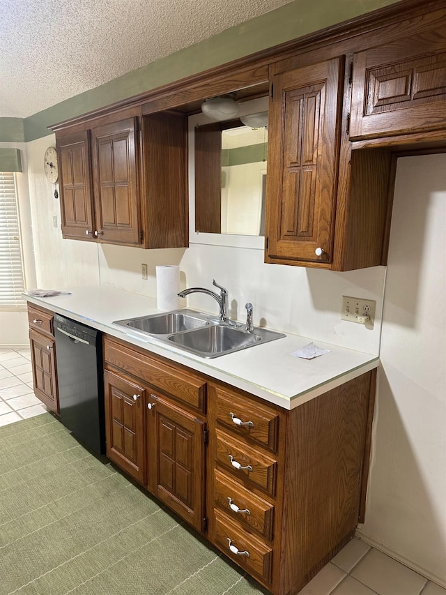 kitchen featuring sink, a textured ceiling, black dishwasher, and light tile patterned flooring