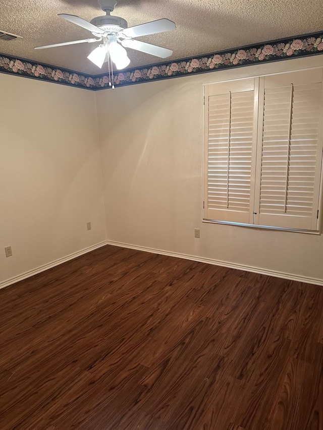 empty room featuring ceiling fan, hardwood / wood-style floors, and a textured ceiling