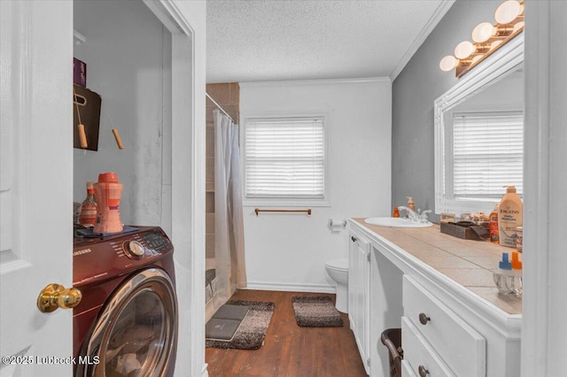 110 E 18th St, Littlefield, TX 79339 - bathroom with washer / clothes dryer, toilet, wood finished floors, a textured ceiling, and vanity