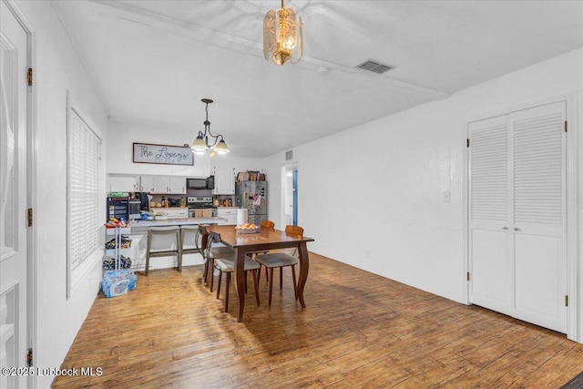 110 E 18th St, Littlefield, TX 79339 - dining area featuring a chandelier and light wood-style flooring