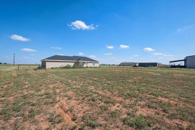 view of yard with a rural view