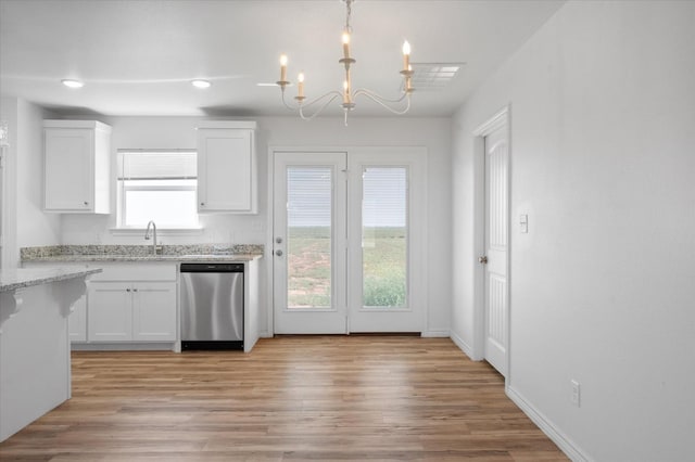 kitchen featuring light stone counters, decorative light fixtures, light hardwood / wood-style flooring, stainless steel dishwasher, and white cabinets