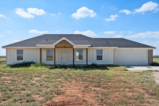 ranch-style home with a garage and a front yard