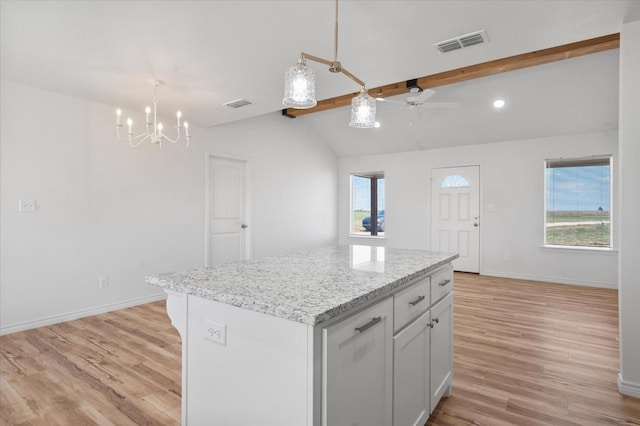 kitchen with white cabinetry, vaulted ceiling with beams, a center island, decorative light fixtures, and light wood-type flooring