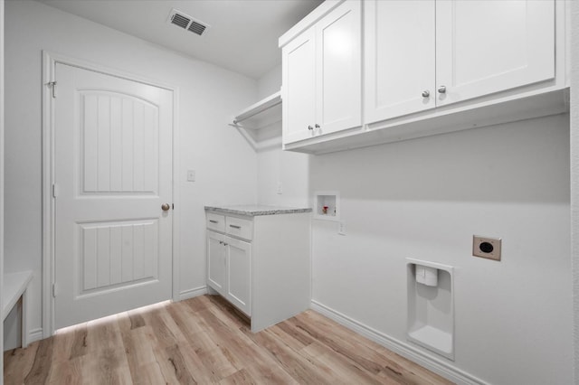 laundry room with cabinets, hookup for a washing machine, light hardwood / wood-style flooring, and hookup for an electric dryer