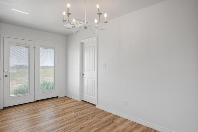 interior space with light hardwood / wood-style flooring and a chandelier