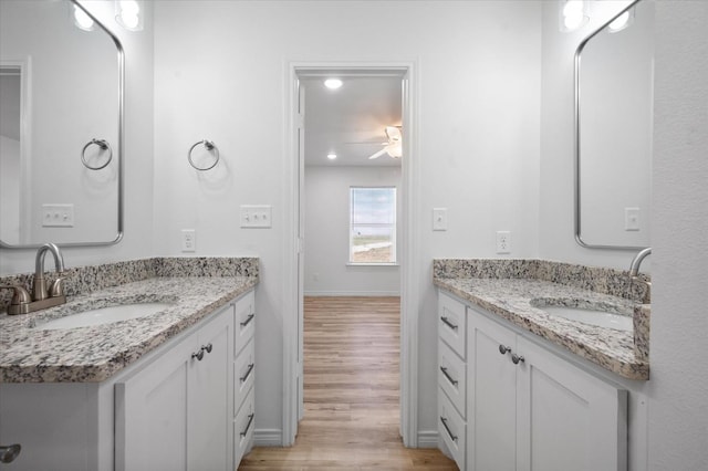 bathroom featuring ceiling fan, vanity, and hardwood / wood-style floors