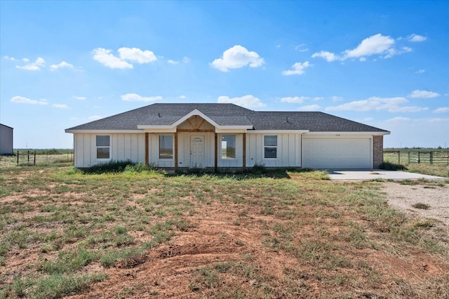 single story home featuring a garage and a front lawn