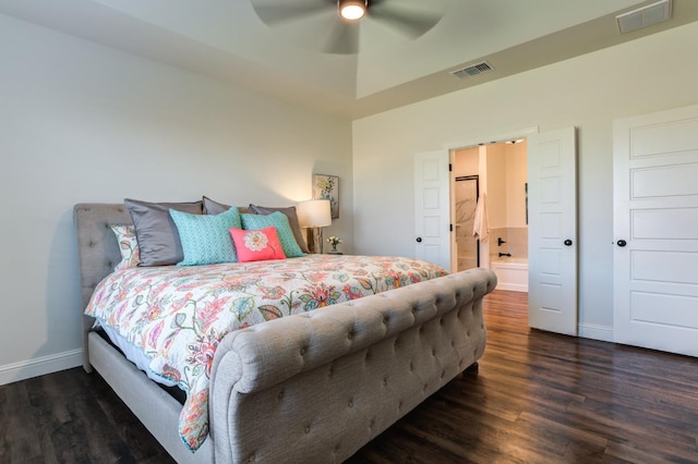 bedroom with ceiling fan, connected bathroom, and dark hardwood / wood-style flooring