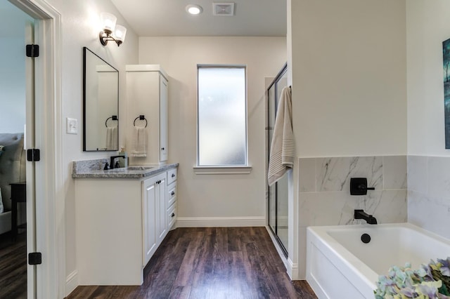 bathroom featuring wood-type flooring, separate shower and tub, and vanity