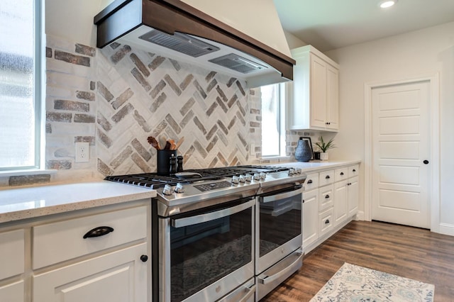 kitchen with white cabinetry, dark hardwood / wood-style floors, decorative backsplash, and stainless steel gas stove