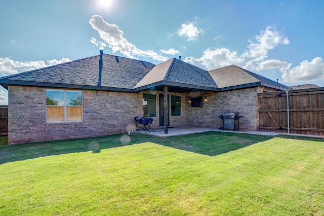 back of property with a patio and a yard