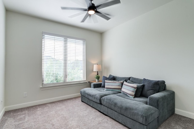 carpeted living room featuring ceiling fan