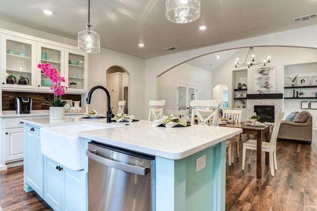 kitchen featuring white cabinetry, an island with sink, pendant lighting, and stainless steel dishwasher