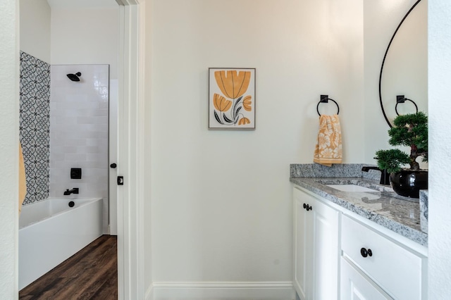 bathroom featuring vanity, hardwood / wood-style floors, and tiled shower / bath