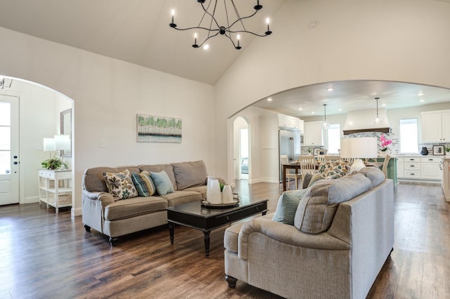 living room with dark hardwood / wood-style floors and high vaulted ceiling