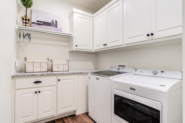 washroom featuring cabinets, separate washer and dryer, and dark wood-type flooring