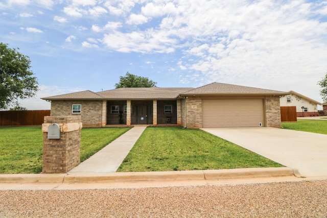 view of front of house with a garage and a front yard