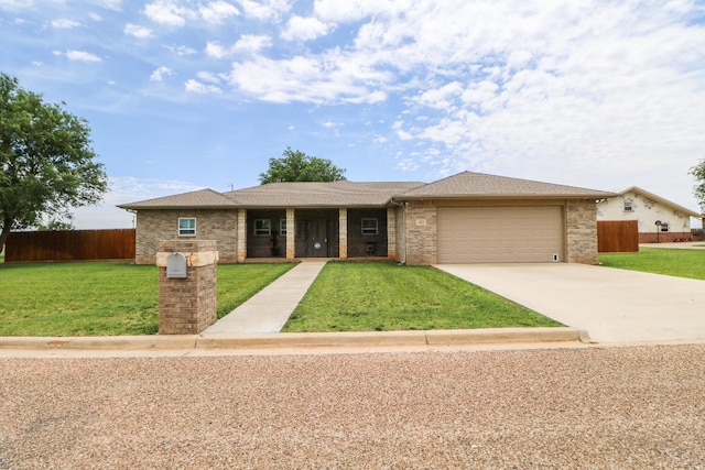 view of front of property featuring a garage and a front yard