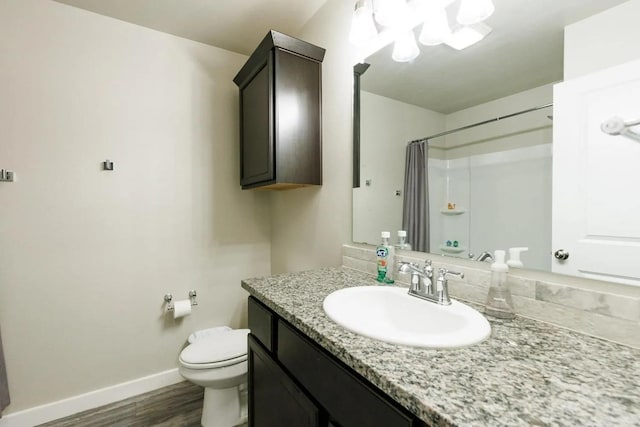 bathroom featuring vanity, wood-type flooring, toilet, and a shower with shower curtain