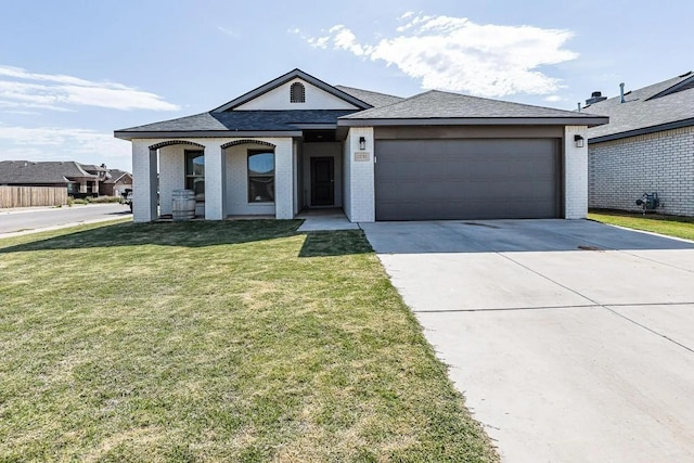 view of front of property featuring a garage and a front yard