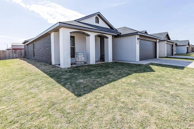 view of front of house featuring a garage and a front lawn