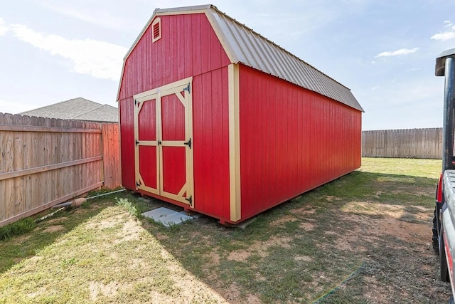 view of outbuilding with a yard