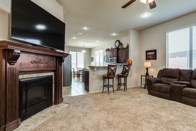 living room featuring light carpet and ceiling fan