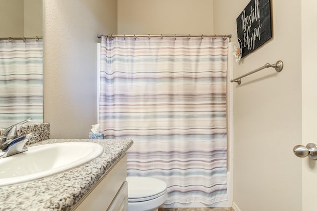 bathroom featuring vanity, toilet, and a shower with shower curtain