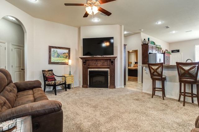 living room featuring light carpet and ceiling fan