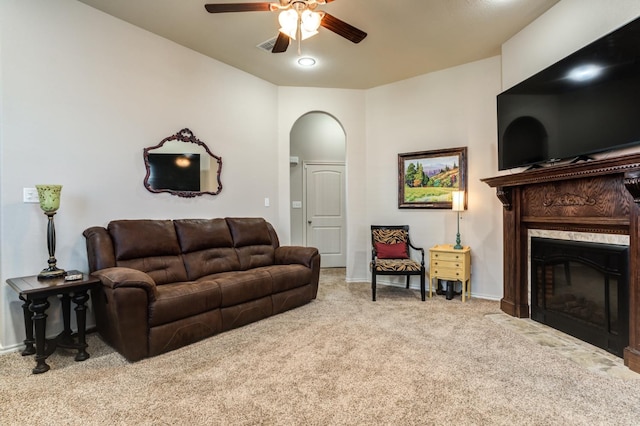 carpeted living room featuring ceiling fan