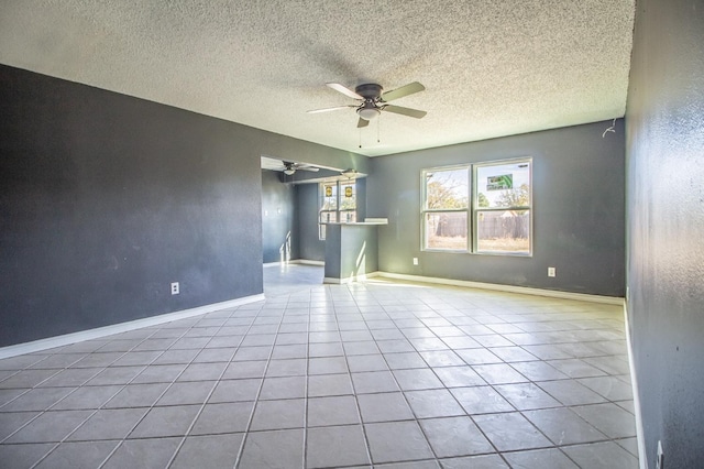 interior space featuring ceiling fan, a textured ceiling, and light tile patterned floors